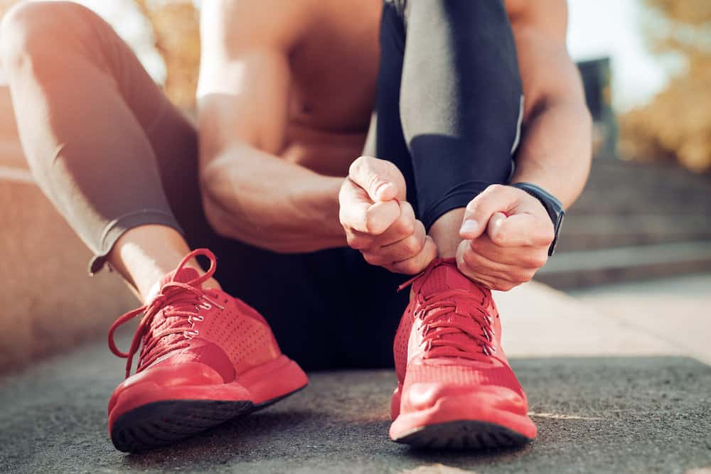 tying laces of running shoes